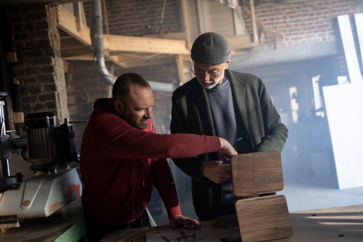 Huub Ubbens and a maker examining wood samples in the workshop